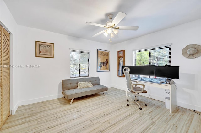 home office with ceiling fan and light hardwood / wood-style floors