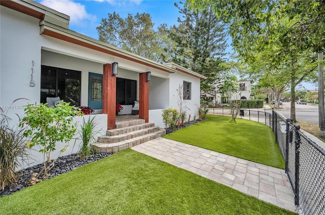 exterior space with a porch and a lawn