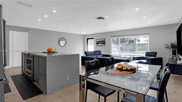 dining space with light hardwood / wood-style flooring