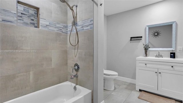 full bathroom featuring vanity, tile patterned floors, tiled shower / bath, and toilet