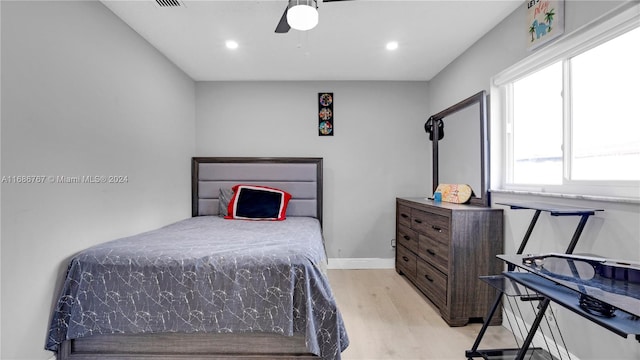 bedroom with ceiling fan and light wood-type flooring