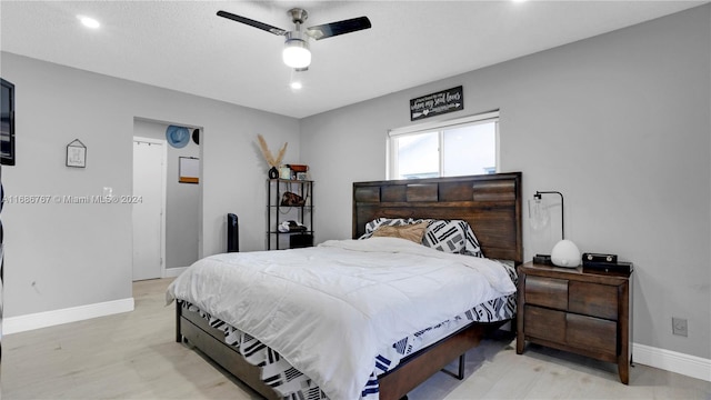 bedroom with light hardwood / wood-style flooring and ceiling fan