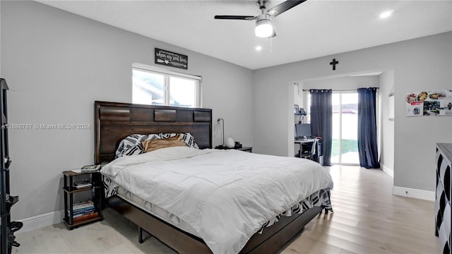 bedroom featuring light hardwood / wood-style flooring, ceiling fan, and access to exterior