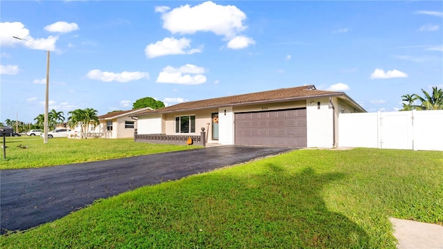 ranch-style home with a garage and a front yard