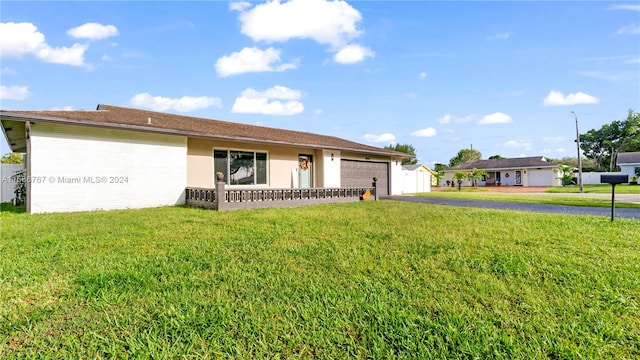 ranch-style house featuring a front lawn and a garage