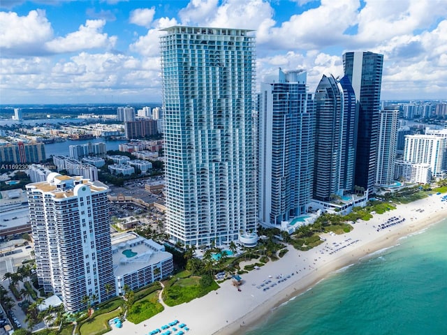 birds eye view of property featuring a water view and a beach view