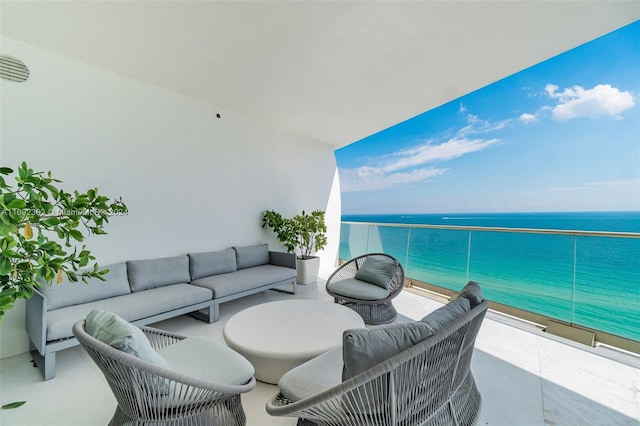 balcony featuring a water view and an outdoor living space