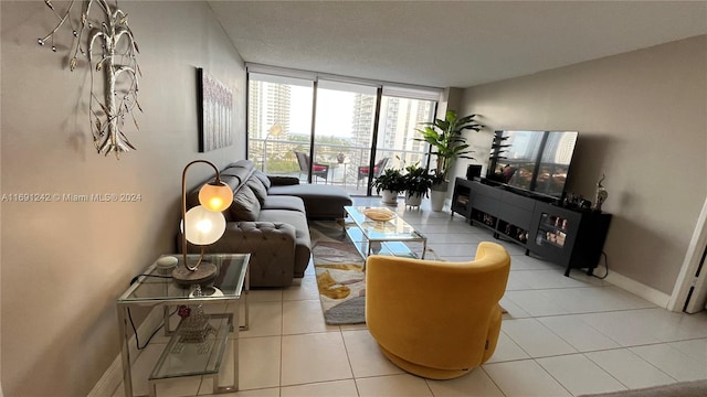 living room featuring floor to ceiling windows and light tile patterned flooring