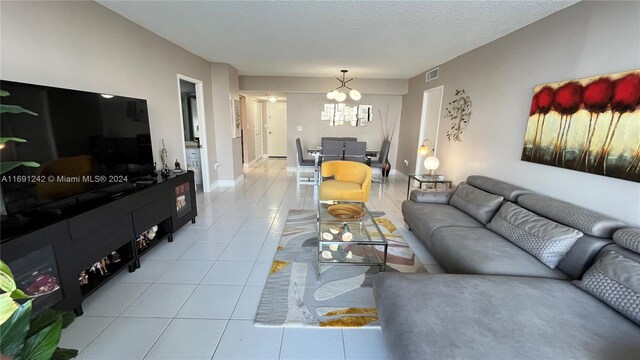 3731 N Country Club Dr Unit 1121, Aventura, FL 33180 - living room with a chandelier, tile patterned floors, baseboards, and a textured ceiling