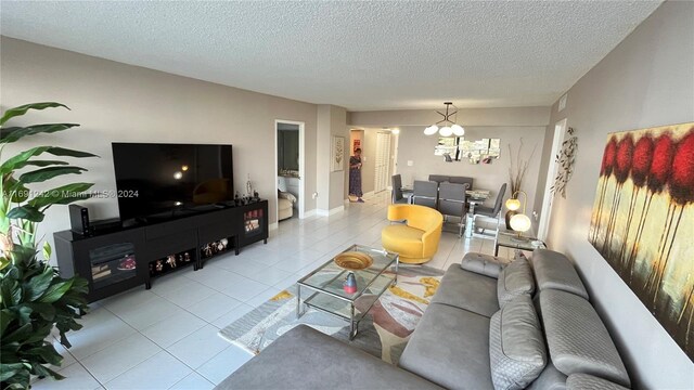3731 N Country Club Dr Unit 1121, Aventura, FL 33180 - living area with light tile patterned floors, a chandelier, and a textured ceiling