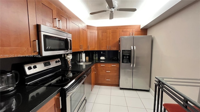 kitchen featuring ceiling fan, light tile patterned floors, and appliances with stainless steel finishes