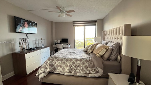 bedroom with ceiling fan and a textured ceiling