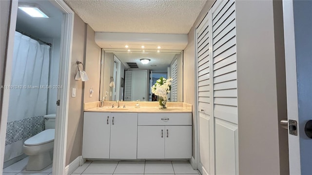 bathroom featuring walk in shower, vanity, a textured ceiling, tile patterned flooring, and toilet