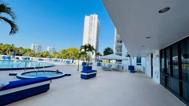 3731 N Country Club Dr Unit 1121, Aventura, FL 33180 - surrounding community with a jacuzzi, a swimming pool, and a patio