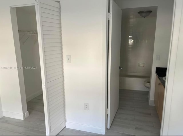 full bathroom with toilet, tiled shower / bath combo, and vanity