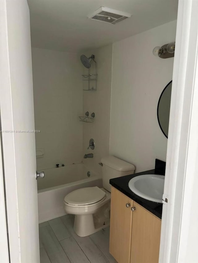 full bathroom featuring shower / bathing tub combination, vanity, hardwood / wood-style flooring, and toilet