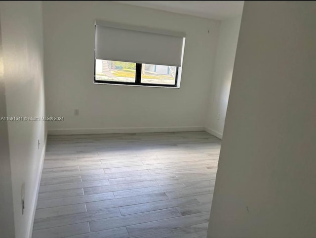 empty room with light hardwood / wood-style flooring