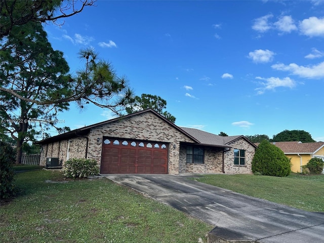 ranch-style house featuring central AC unit, a garage, and a front yard