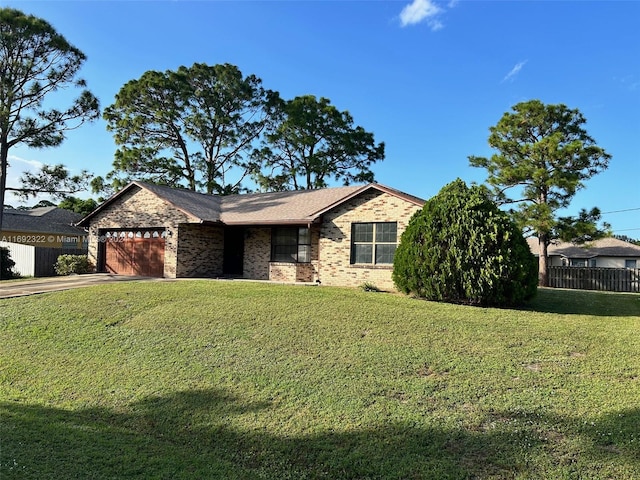 view of front of house featuring a garage and a front lawn