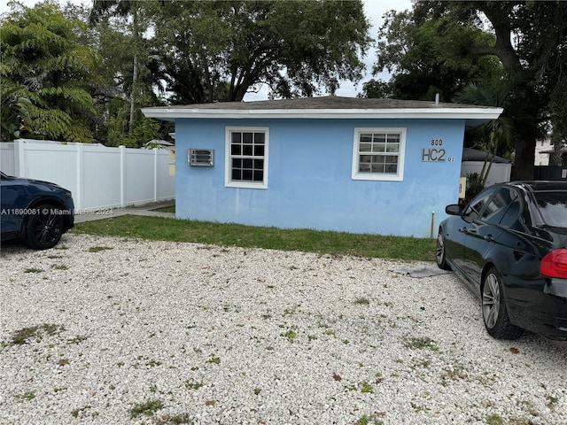 view of property exterior featuring a wall mounted air conditioner