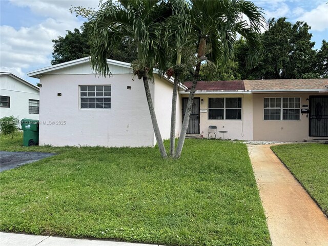 ranch-style house with a front lawn