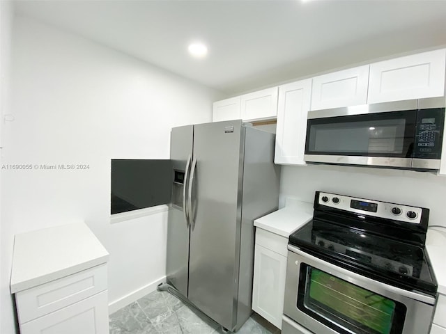 kitchen featuring white cabinetry and stainless steel appliances