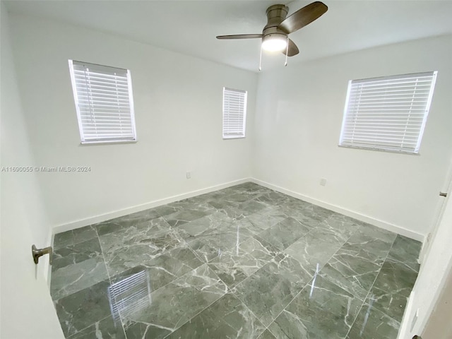 unfurnished room with ceiling fan