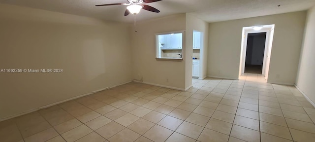 tiled empty room with ceiling fan