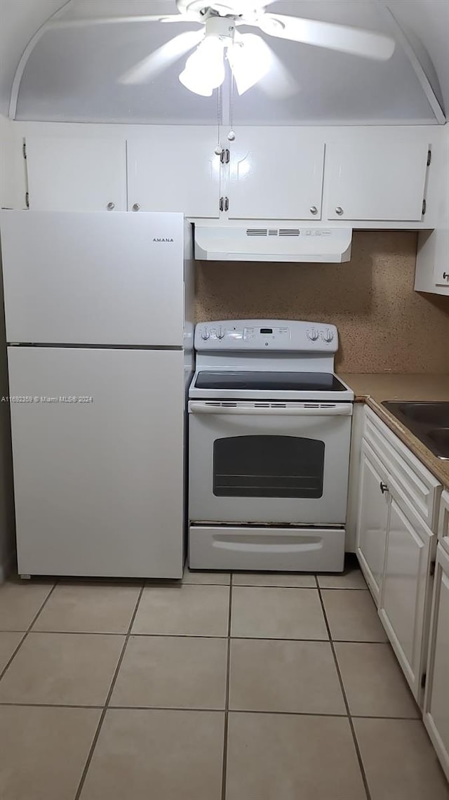 kitchen with light tile patterned flooring, ceiling fan, white appliances, ventilation hood, and white cabinets