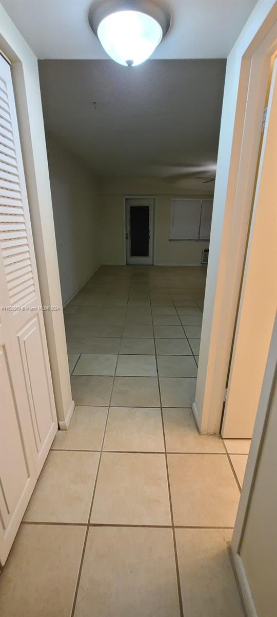 hallway with light tile patterned floors