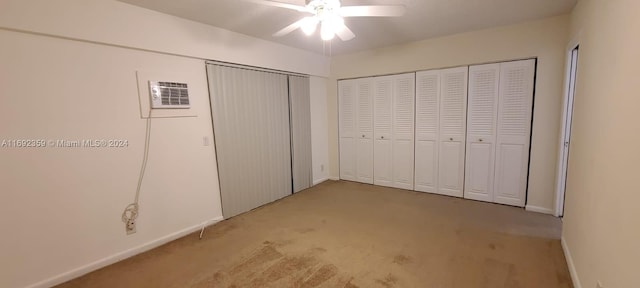 unfurnished bedroom featuring an AC wall unit, light carpet, and ceiling fan