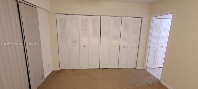 unfurnished bedroom featuring light carpet