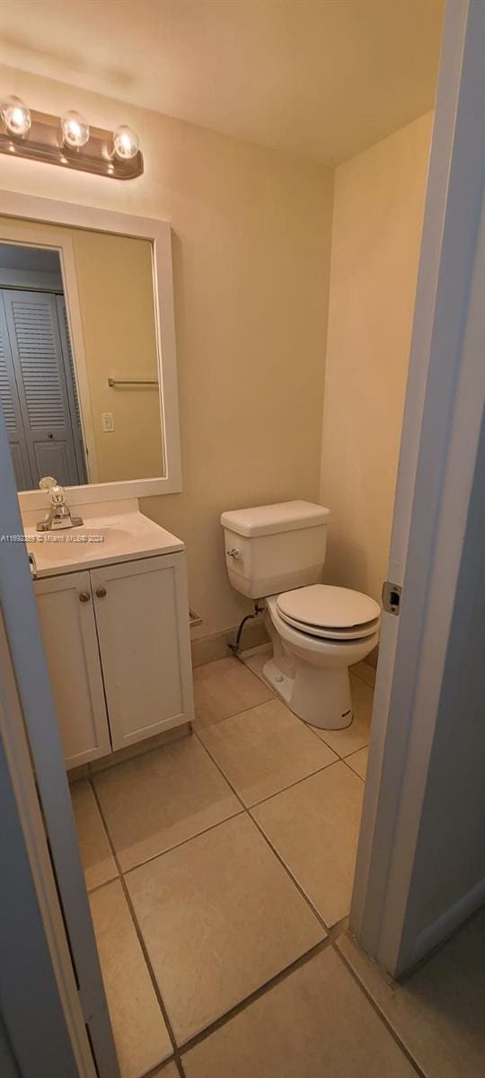 bathroom with vanity, tile patterned floors, and toilet