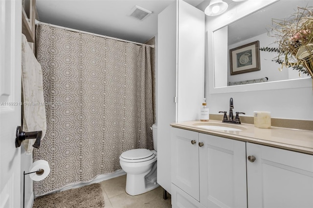 bathroom featuring toilet, vanity, and tile patterned floors