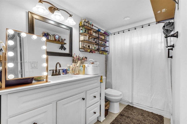 bathroom featuring toilet, vanity, and tile patterned floors