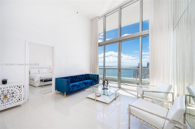 495 Brickell Ave Unit 4103, Miami, FL 33131 - living area featuring a high ceiling, a water view, tile patterned flooring, and a wall of windows