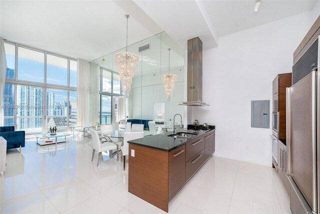 495 Brickell Ave Unit 4103, Miami, FL 33131 - kitchen with modern cabinets, exhaust hood, a sink, a high ceiling, and appliances with stainless steel finishes