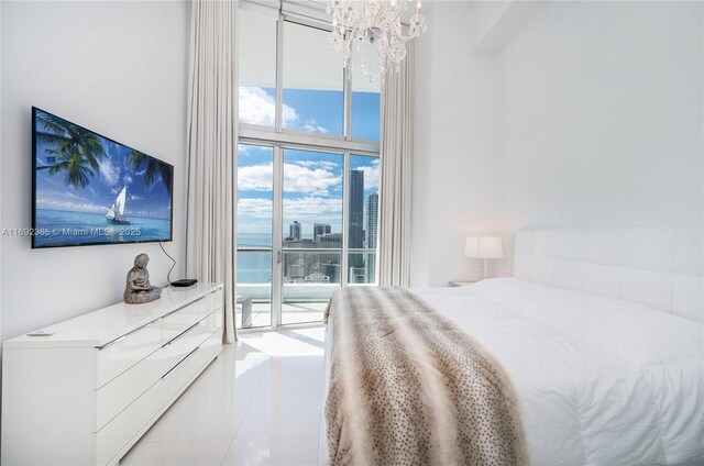 495 Brickell Ave Unit 4103, Miami, FL 33131 - bedroom featuring a chandelier, access to exterior, expansive windows, multiple windows, and tile patterned floors