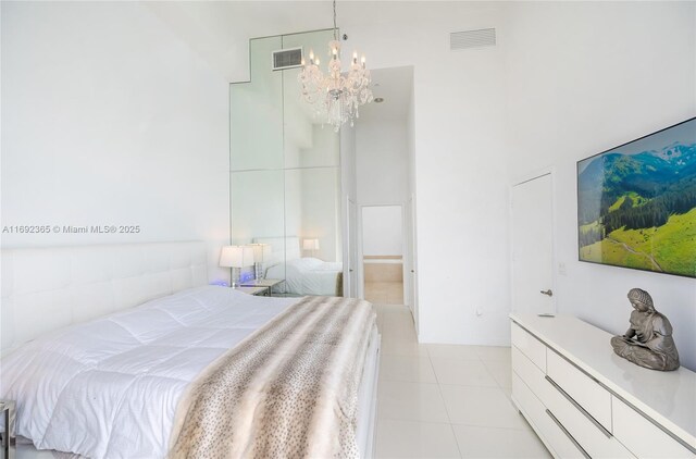 495 Brickell Ave Unit 4103, Miami, FL 33131 - bedroom with a chandelier, a towering ceiling, and light tile patterned flooring