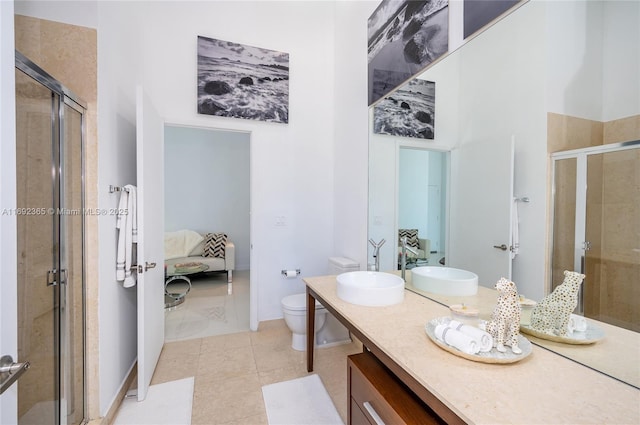 495 Brickell Ave Unit 4103, Miami, FL 33131 - ensuite bathroom featuring a shower stall, vanity, toilet, and tile patterned flooring