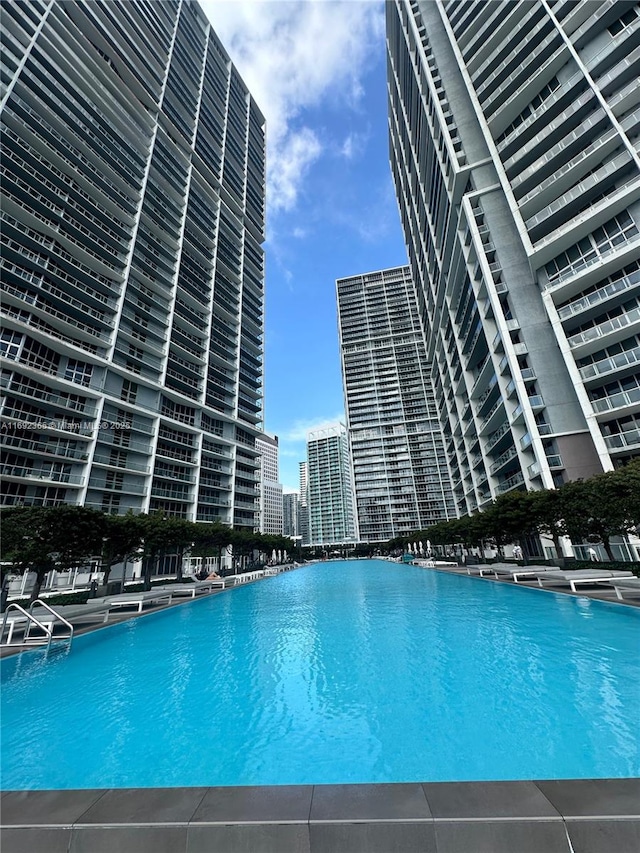 view of pool with a city view