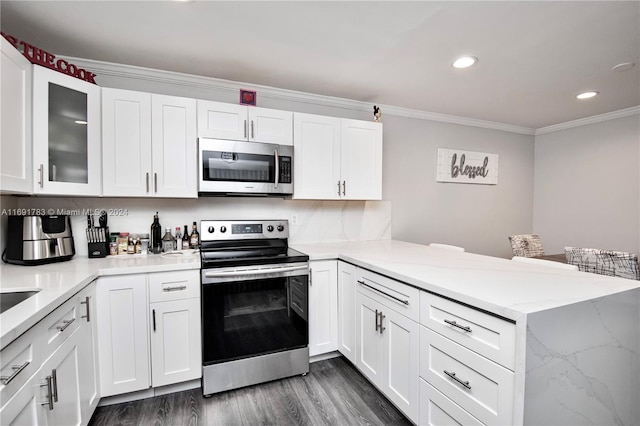 kitchen with kitchen peninsula, white cabinetry, ornamental molding, and appliances with stainless steel finishes