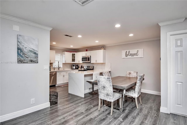 dining room featuring crown molding and wood-type flooring