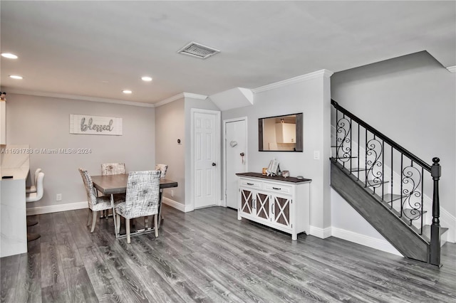 dining area with dark hardwood / wood-style floors and ornamental molding