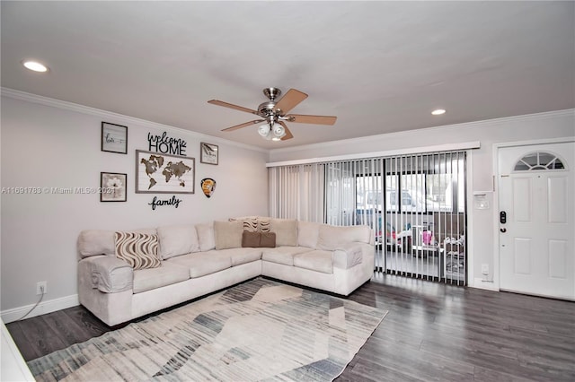 living room featuring dark hardwood / wood-style floors, ceiling fan, and crown molding