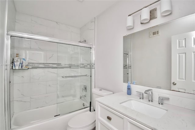 full bathroom featuring vanity, toilet, and enclosed tub / shower combo