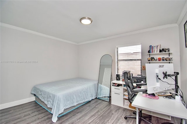 bedroom with hardwood / wood-style flooring and ornamental molding