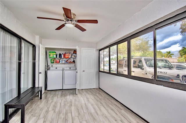 sunroom with separate washer and dryer and ceiling fan