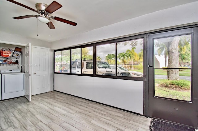 interior space with light hardwood / wood-style flooring, a healthy amount of sunlight, and washer / dryer