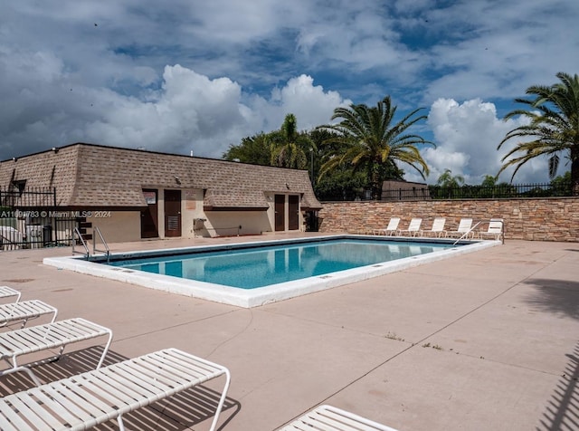 view of swimming pool with a patio area